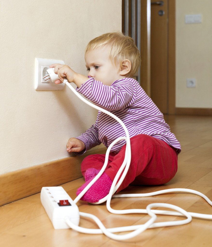 child playing with an electric extension cord