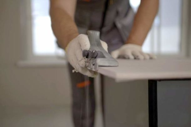 Removing a chamfer from a sheet of drywall