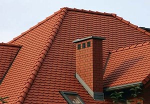 Chimney passing through a wooden ceiling