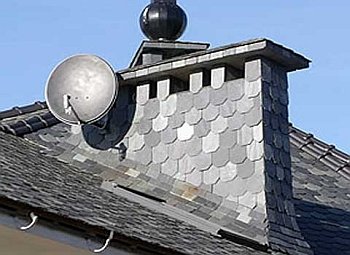 Chimney passing through a wooden ceiling