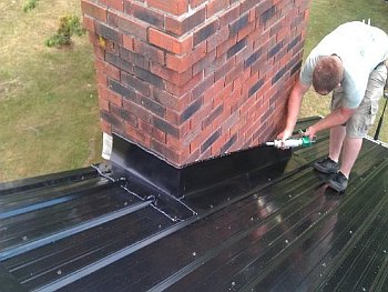 Chimney passing through a wooden ceiling