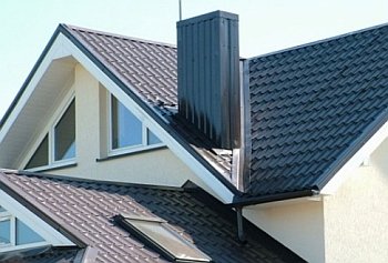 Chimney passing through a wooden ceiling