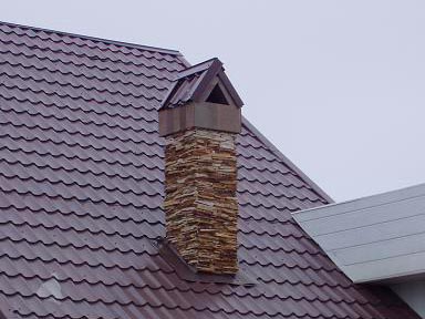 Chimney passing through a wooden ceiling