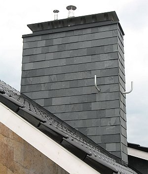 Chimney passing through a wooden ceiling